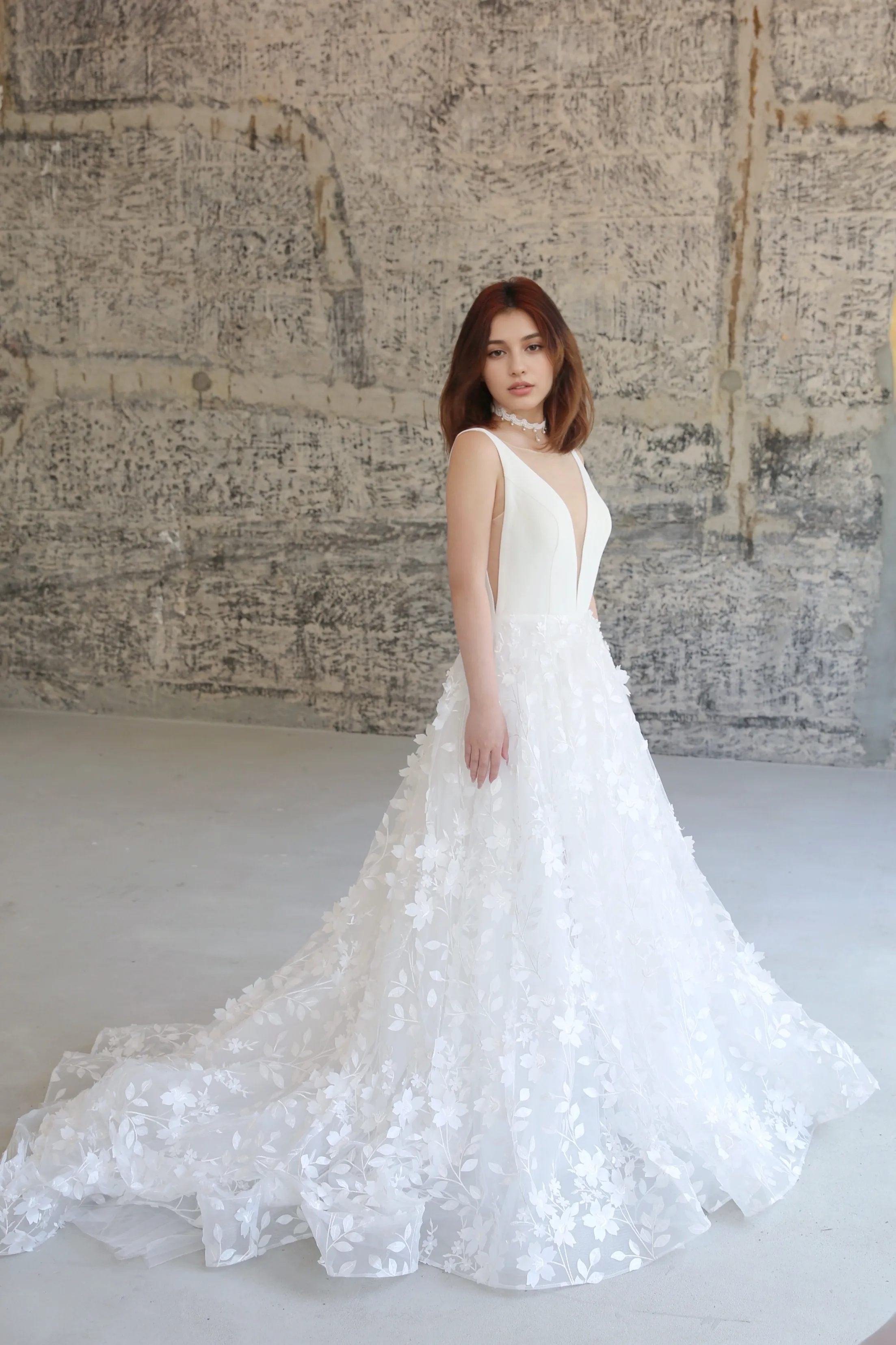 Style E2408 - Deep-V neck Satin bodice 3D floral lace skirt A-line thigh slit modern wedding dress